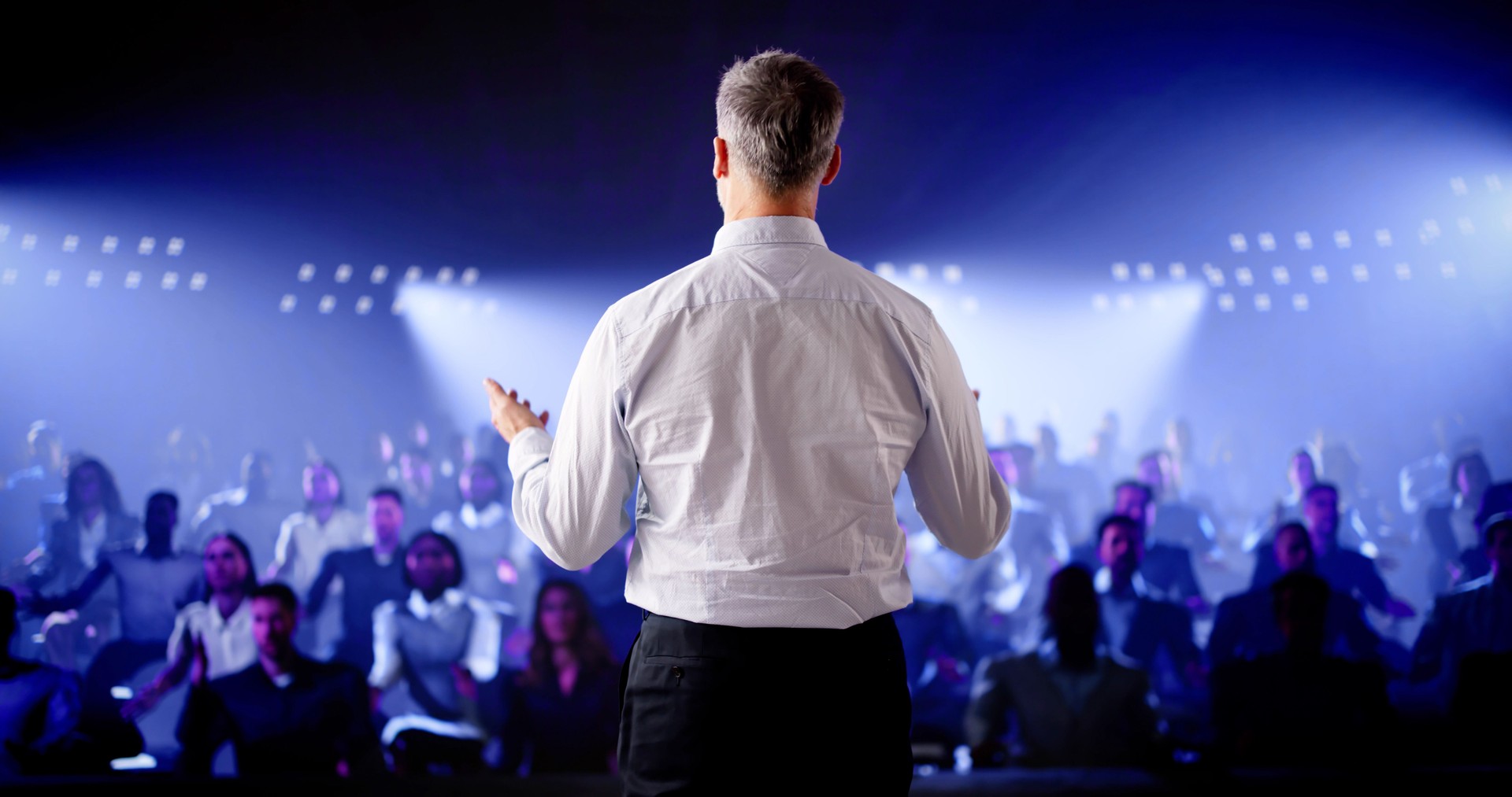 Corporate Speaker Giving Business Speech To Audience At Meeting